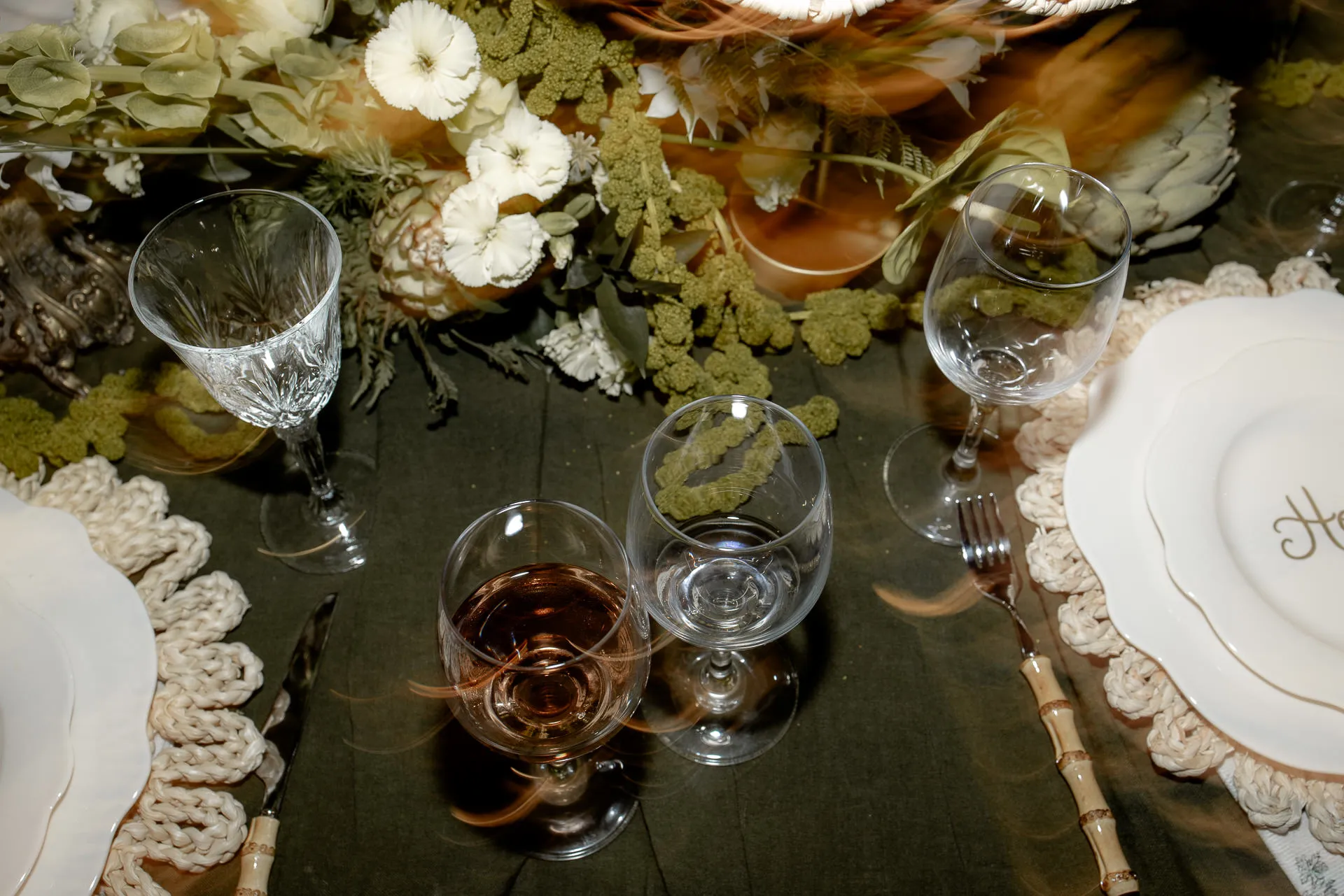 Luxurious wedding table details with green velvet tablecloth and golden flowers at Chateau de Varennes